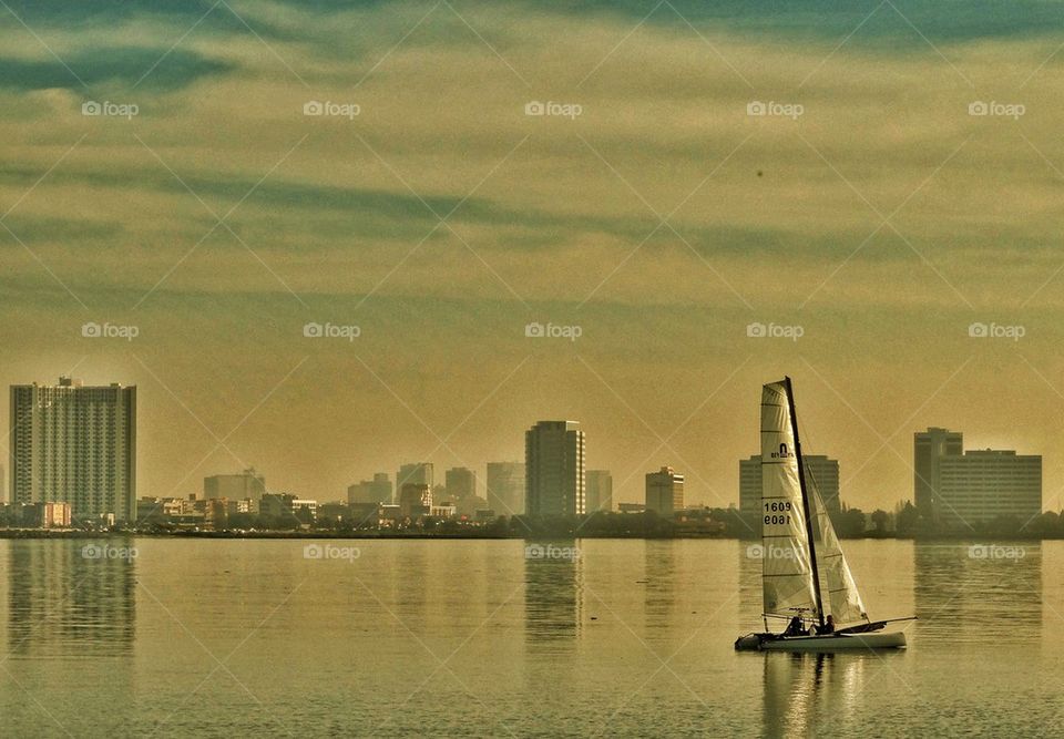 Sailboat On San Francisco Bay Against Oakland Skyline. Sailing On San Francisco Bay With Oakland In The Background
