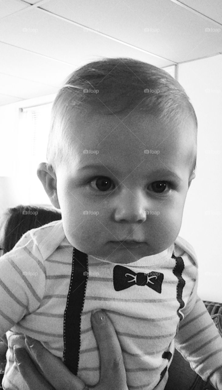 This baby is checking out the man behind the camera at his first Thanksgiving 