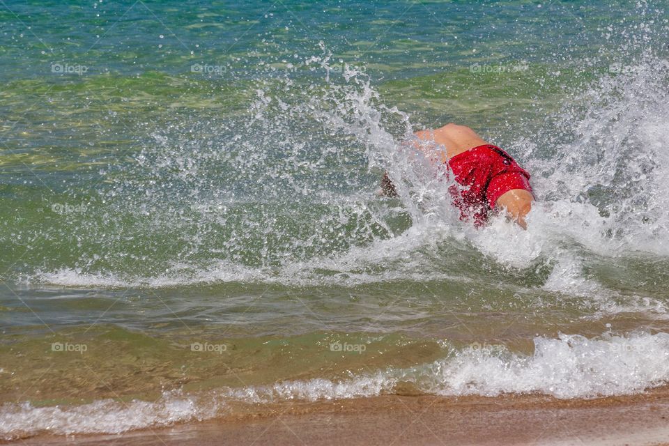 Boy dives into the sea
