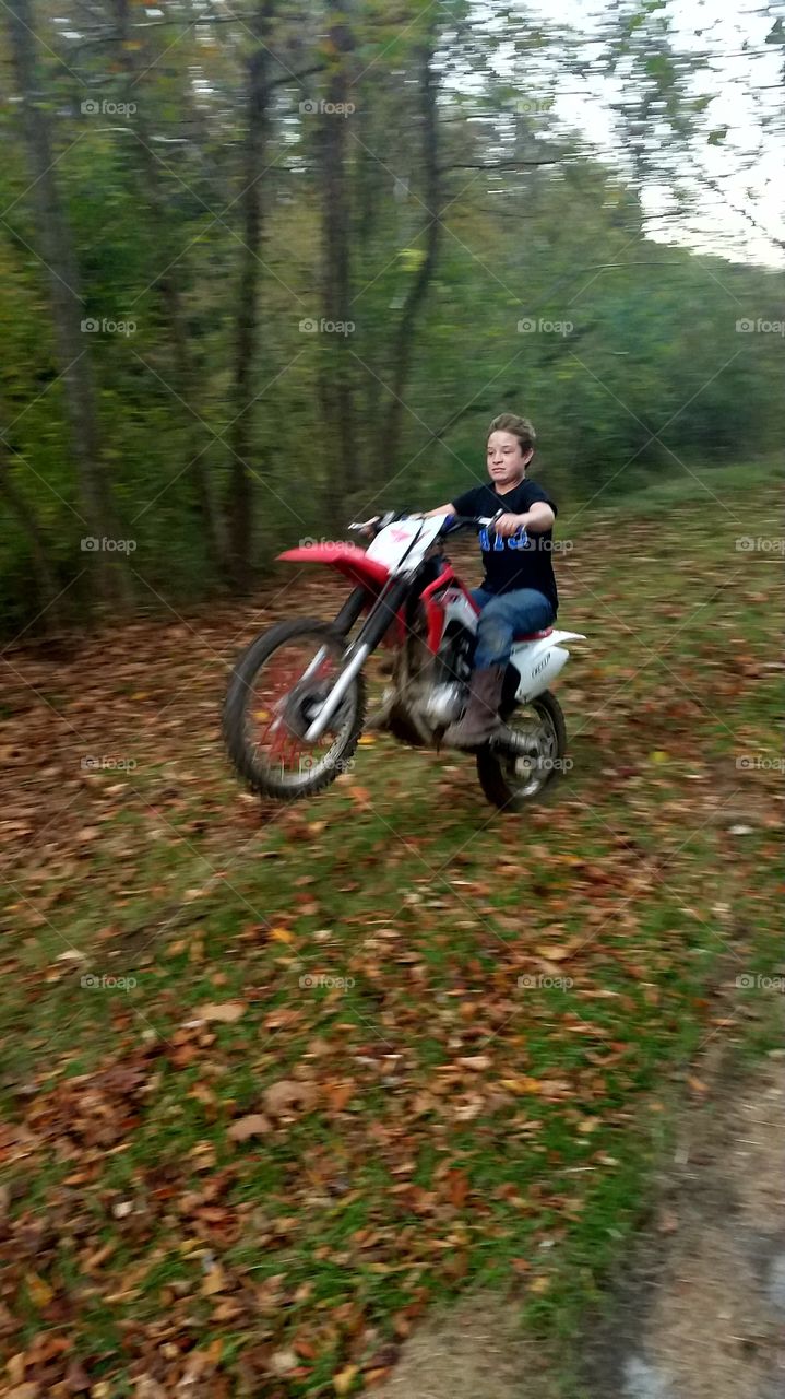 Man riding motorcycle in forest