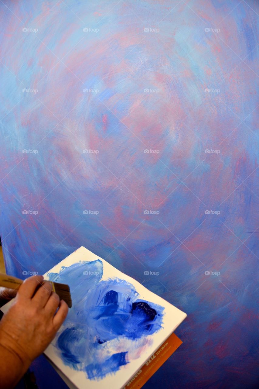 A person painting on a paper