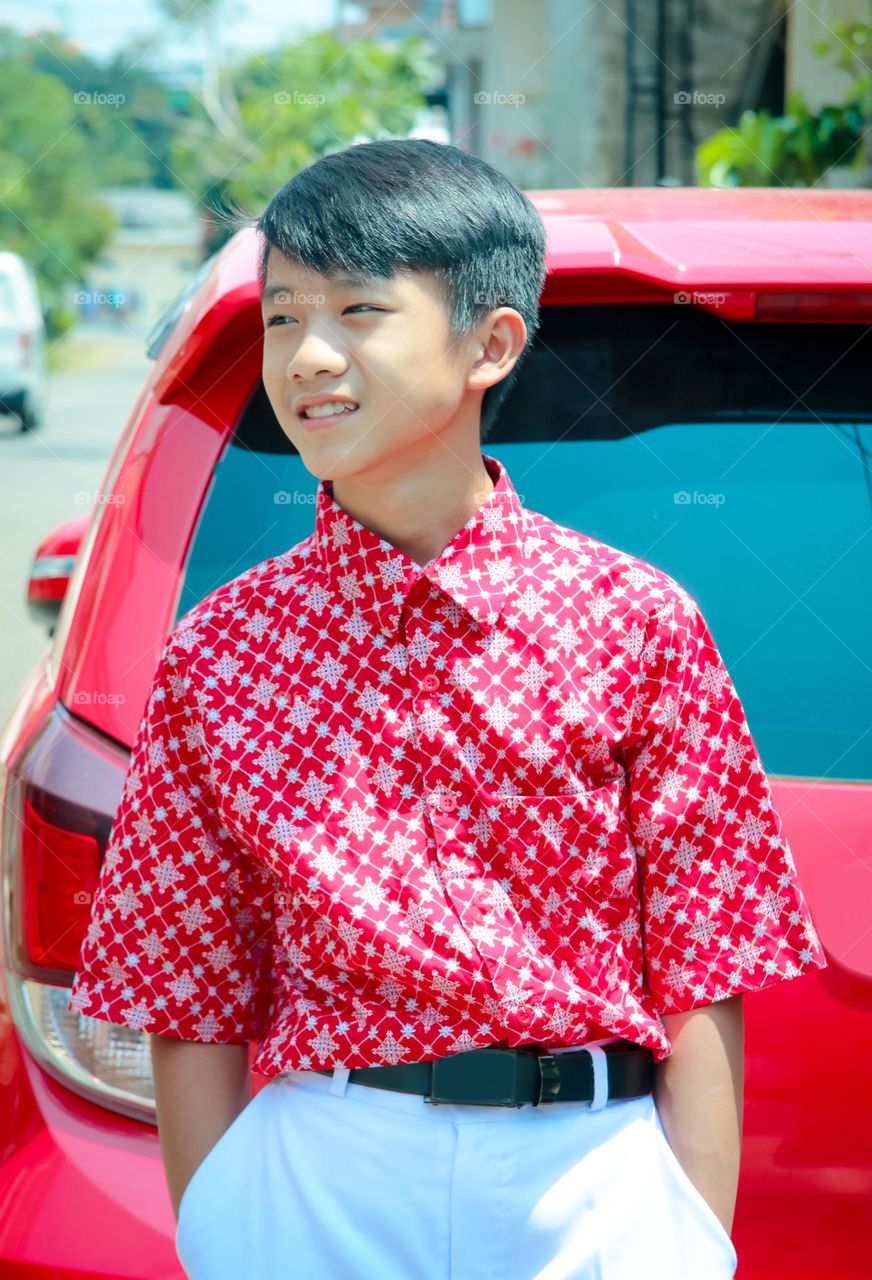 a young boy wearing uniform and pose for a while