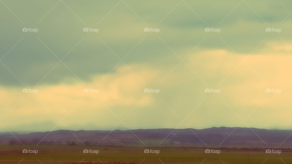 Landscape in motion, driving through the flat farmland in the Karoo on a stormy wet winter afternoon