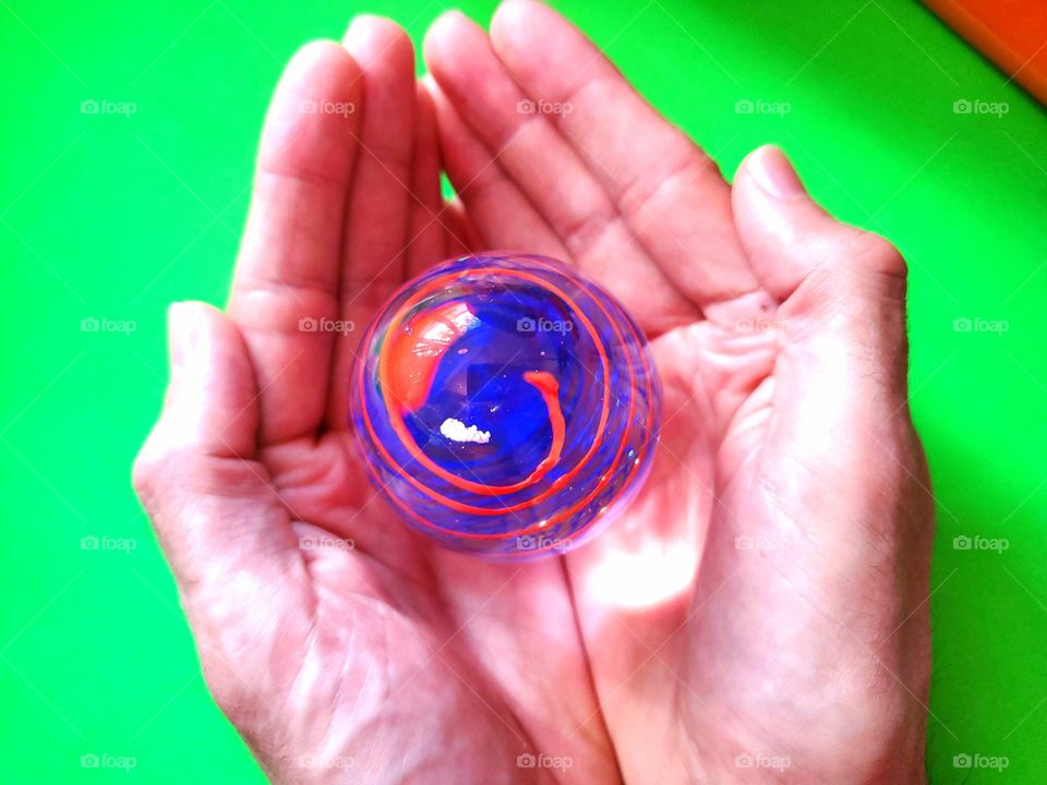 Concept - hands holding creative art glass