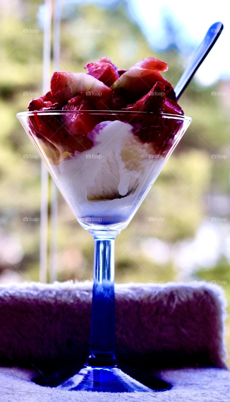 Ice cream and strawberries on balcony