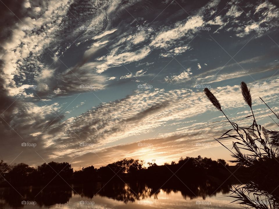 With a break in the evening sky heavy clouds melt with the cooling ceiling above allowing more colors to be visible. 