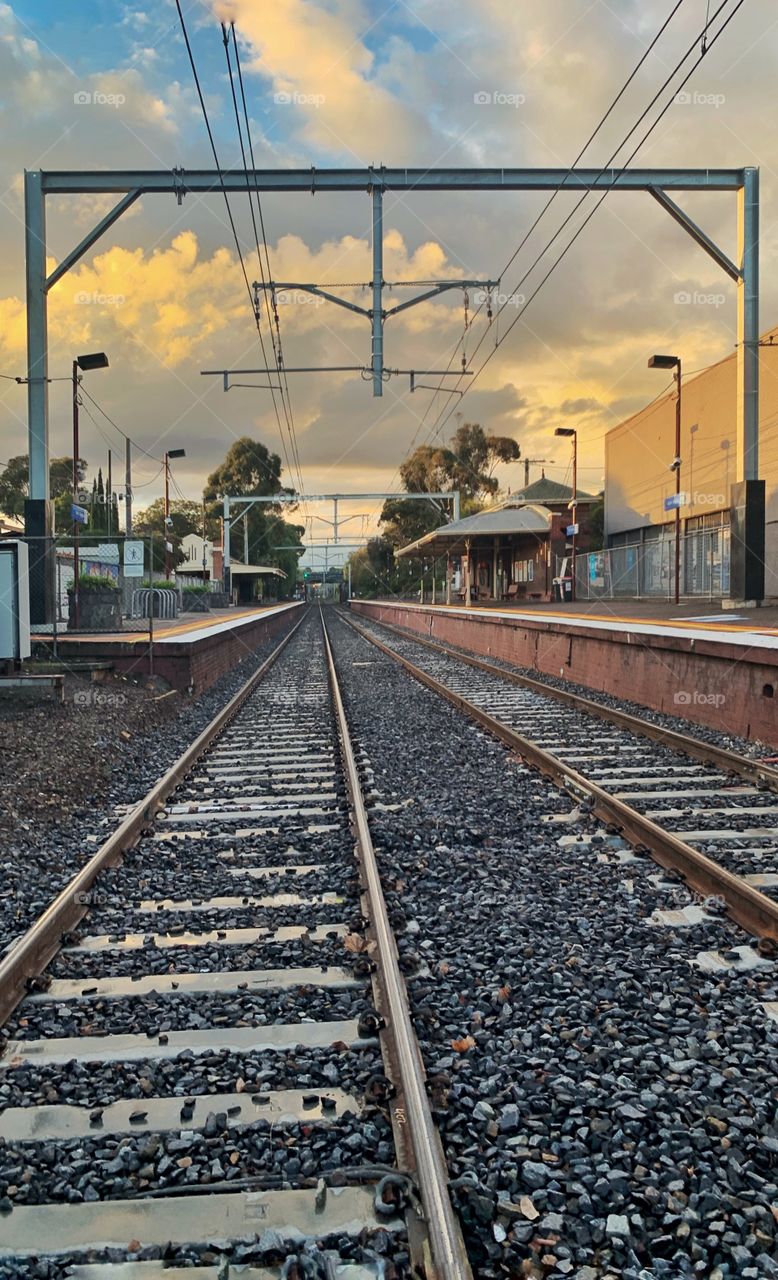 Perspective ~ on the tracks, into the depths, a quiet suburban railway station in Melbourne. Vanishing point for trains. 