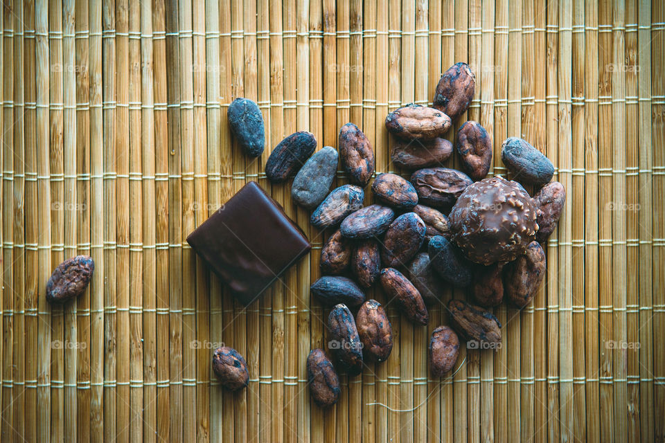 Coffee and cacao beans on bamboo background