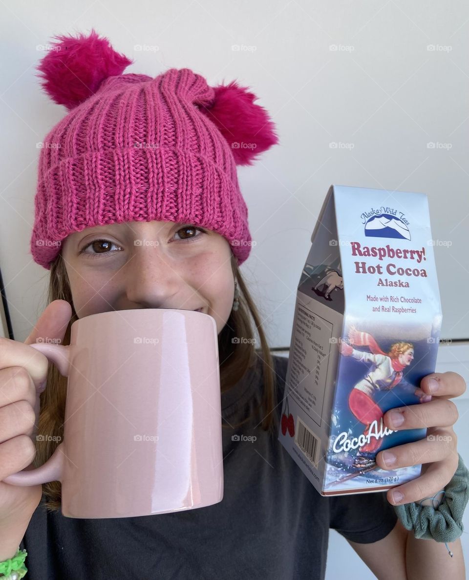 The joy of drinking a Raspberry Hot Cocoa drink while wearing a raspberry beanie.