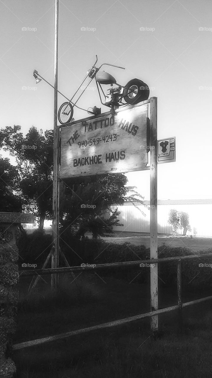 backhoe service. This is the black and white version of a sign advertising a backhoe service