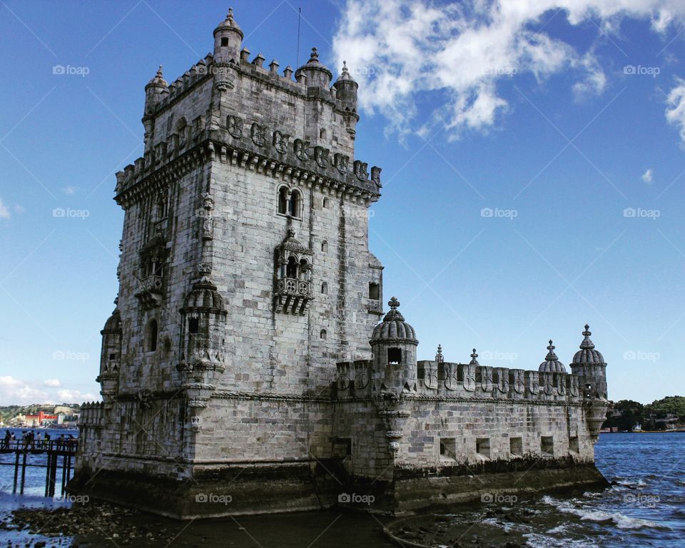 The castle was built in the Tagus River.
After 100 of years the river has being moved. 
Now the castle is at the bank of the river. 
And it is now a tourist attraction.