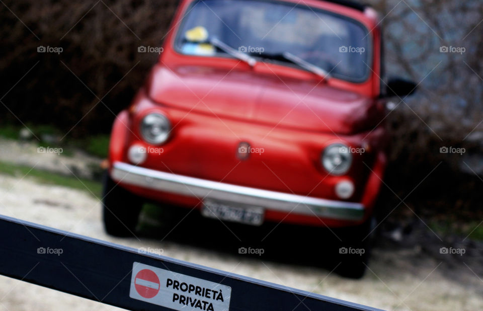 Red Cinquecento parked at private property in Sienna