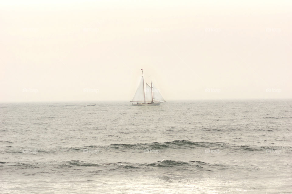 boat on the ocean. a boat dailing on a foggy day