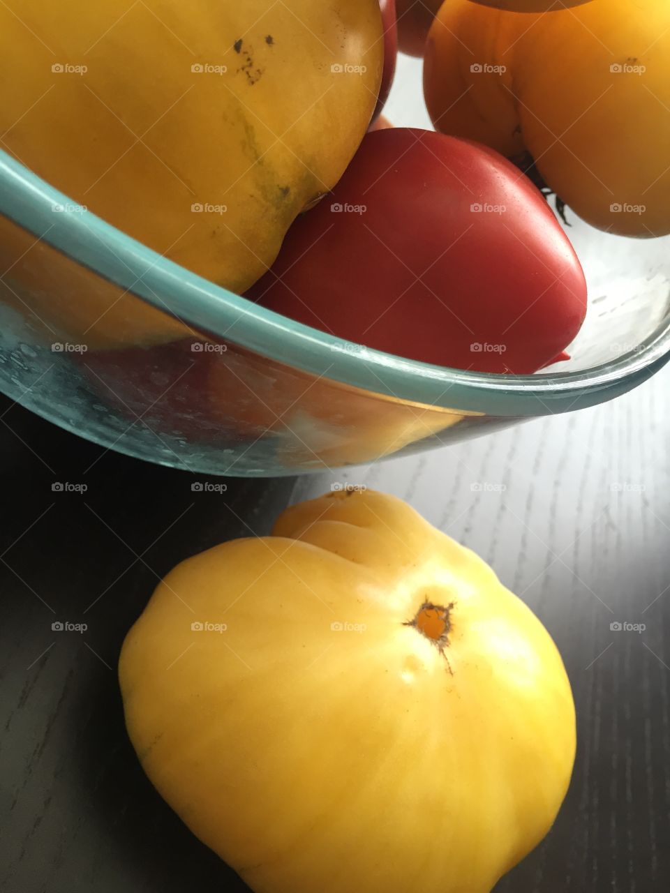 Red and yellow tomatoes in the glass bowl