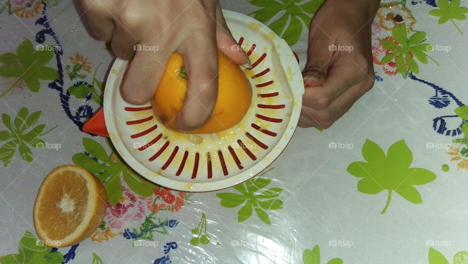 Hand and juice of orange