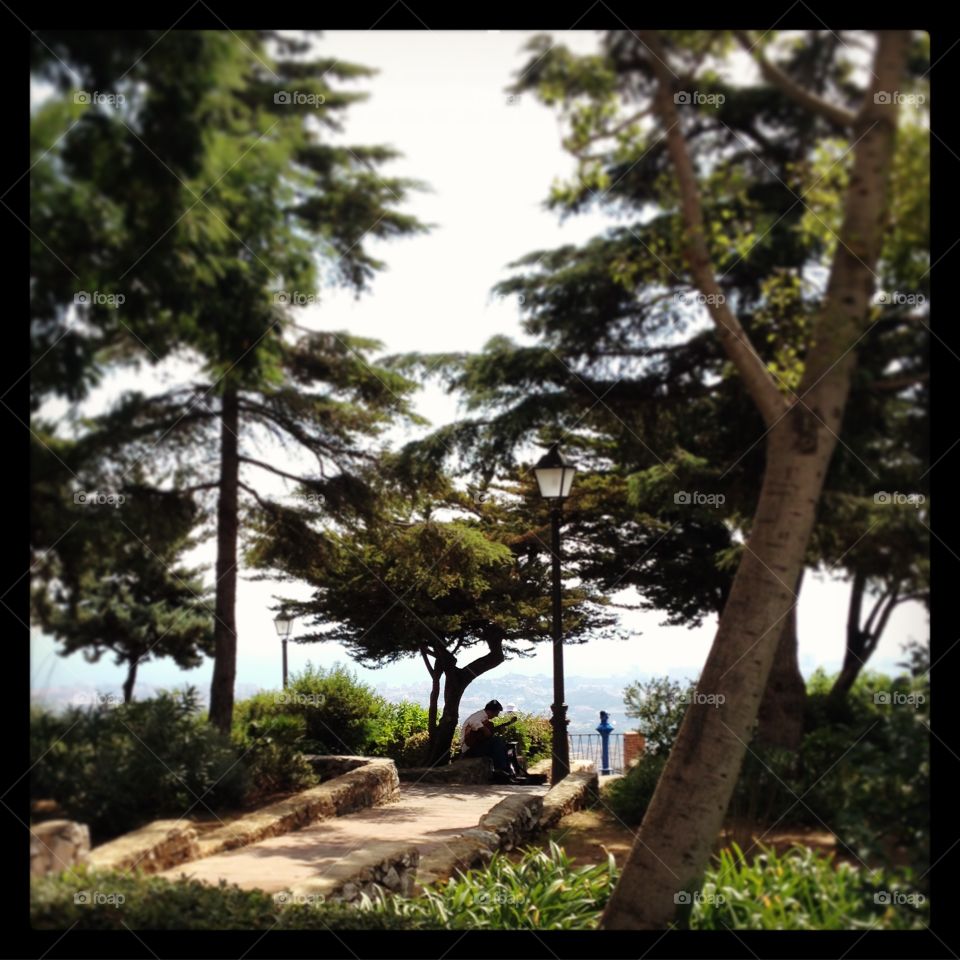 Man playing guitar overlooking Mijas Costa, Spain