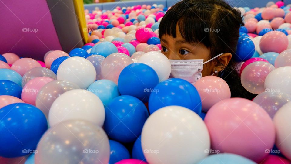 Play in a pool filled with colorful balls at the indoor playground