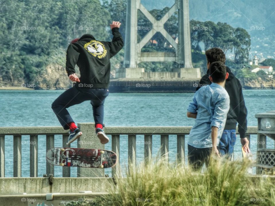 Skateboarder Performing 720 Flip Trick. Skating In San Francisco Along The Embarcerdo