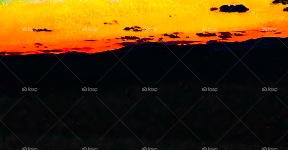 Golden rays cresting over the mountains in order to welcome in the new day. 