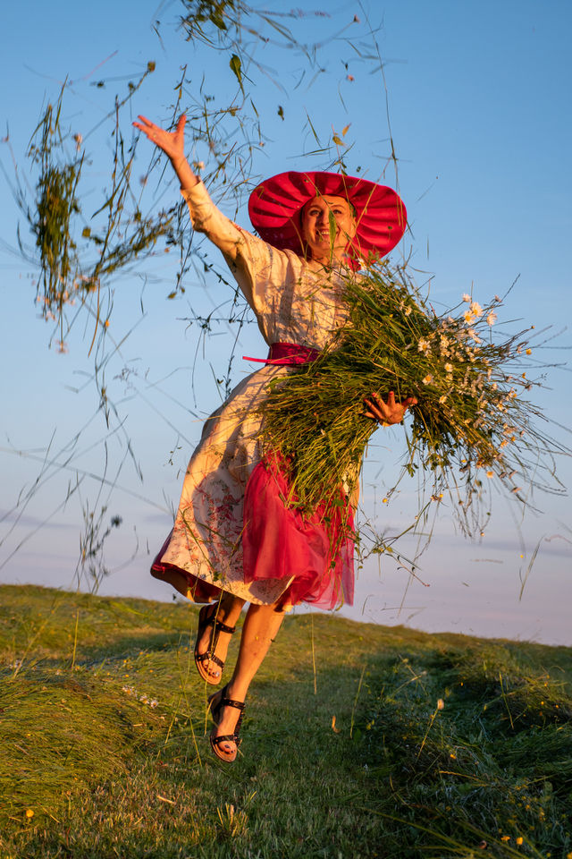A Happy Young Woman with an Armful of Flowers