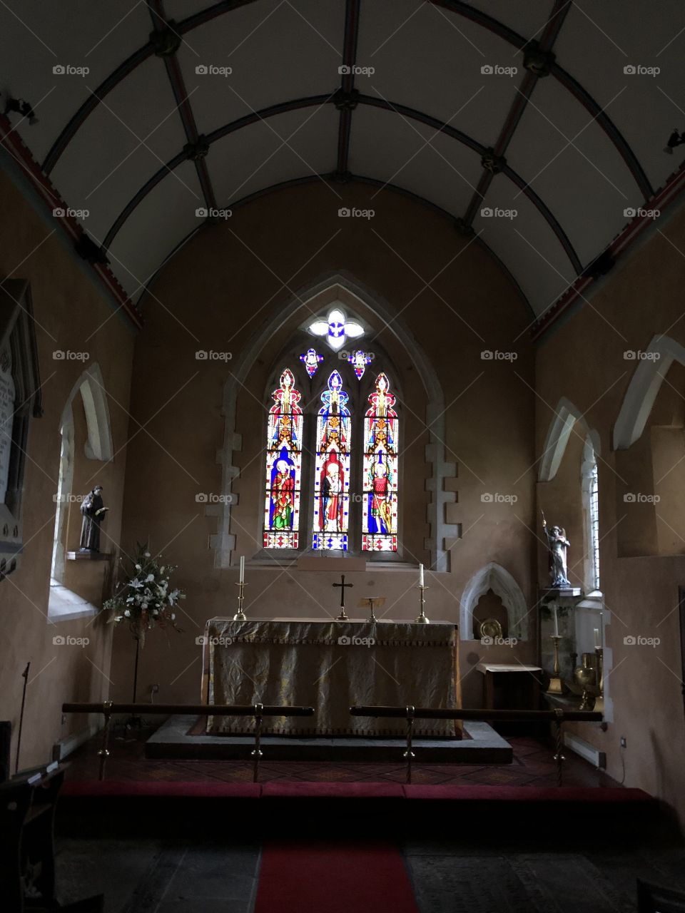 The Church of St Michael, Ilsington, Dartmoor, from an internal perspective, with the impressive stained glassed window, one of the features.