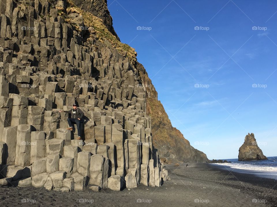 Basalt rock columns on the black sand beach in Vik, Iceland. 