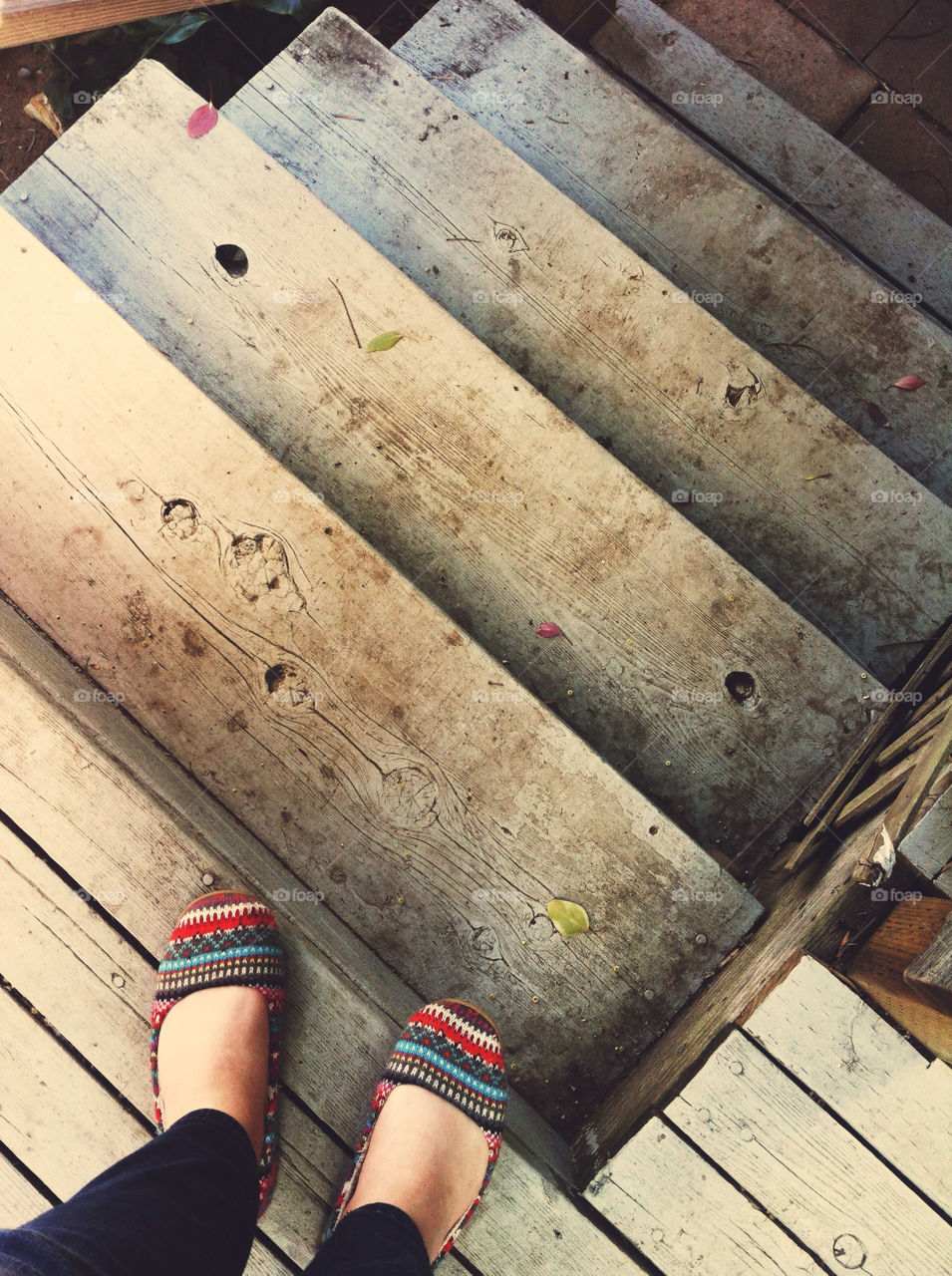 Feet on dirty stairs.