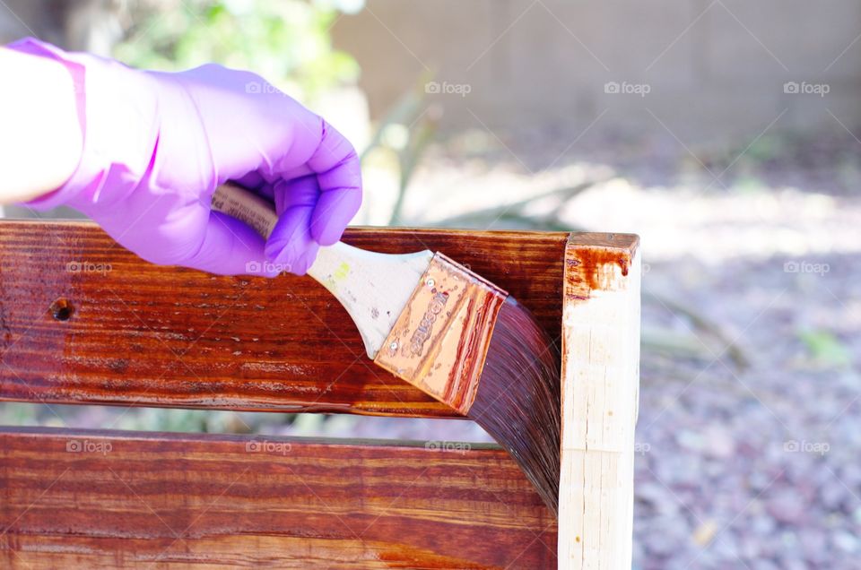 Applying wood stain to  a homemade wine rack.