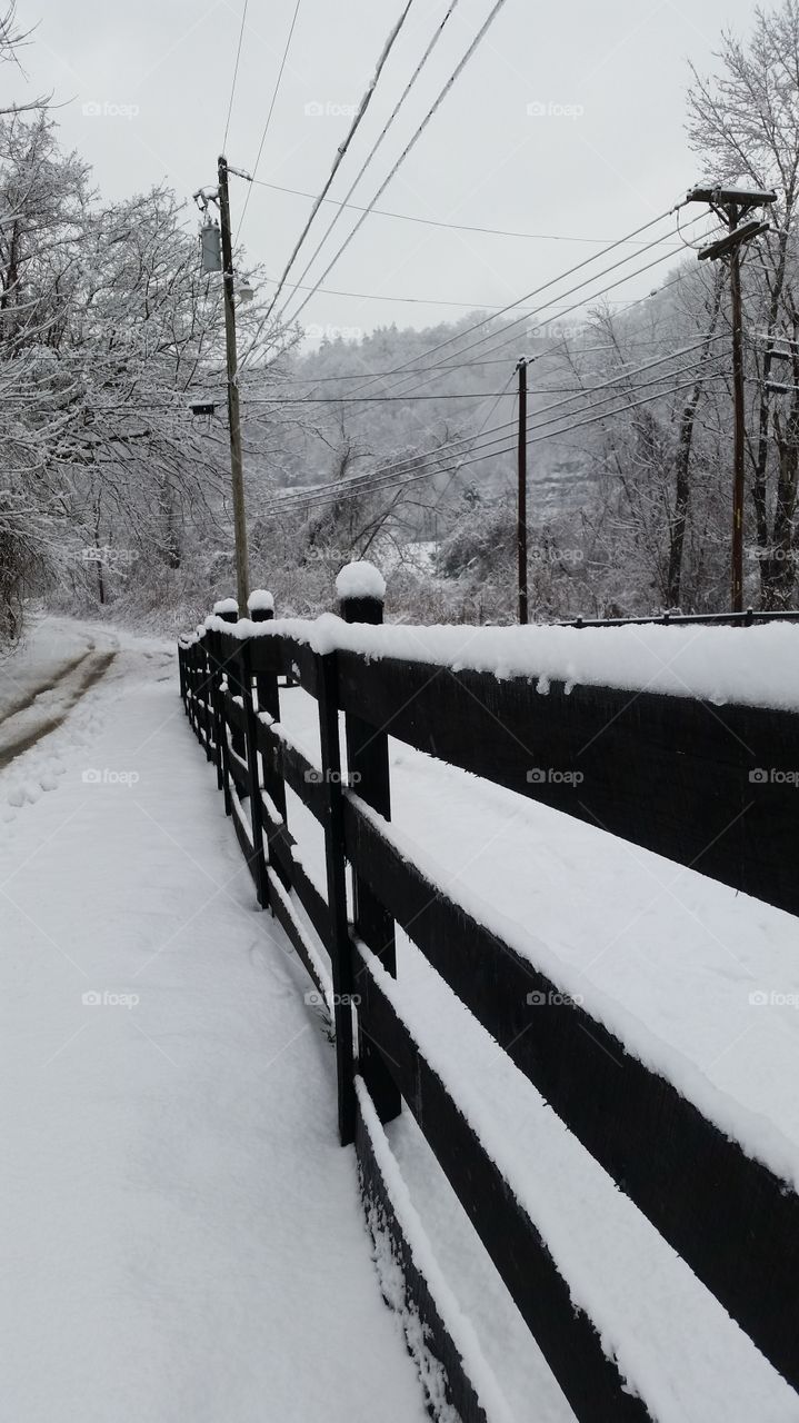 black fence snowy day