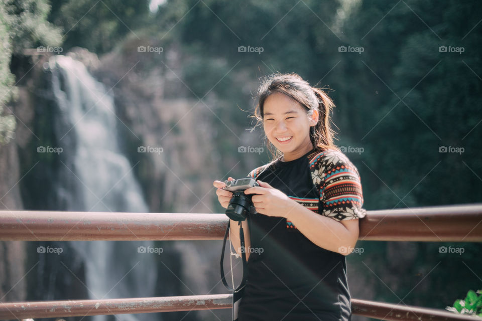 Asian cute tourist girl with camera 