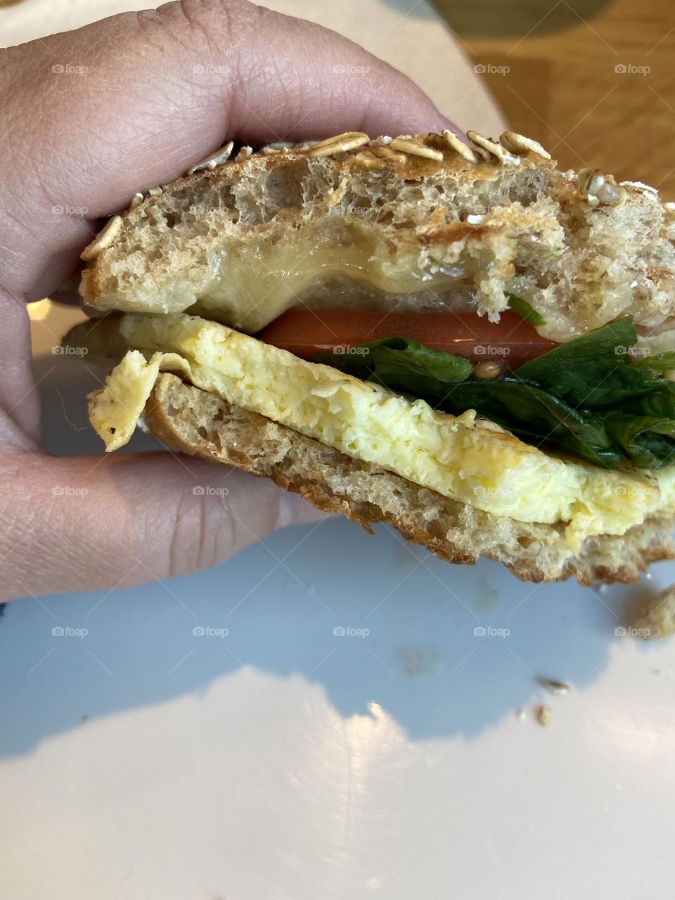 A scrambled egg and cheese with spinach and tomato on a sprouted grain bagel flat that I enjoyed at a local Panera  Bread. I love Panera because I can customize my breakfast sandwich to add some vegetables to my morning meal. 