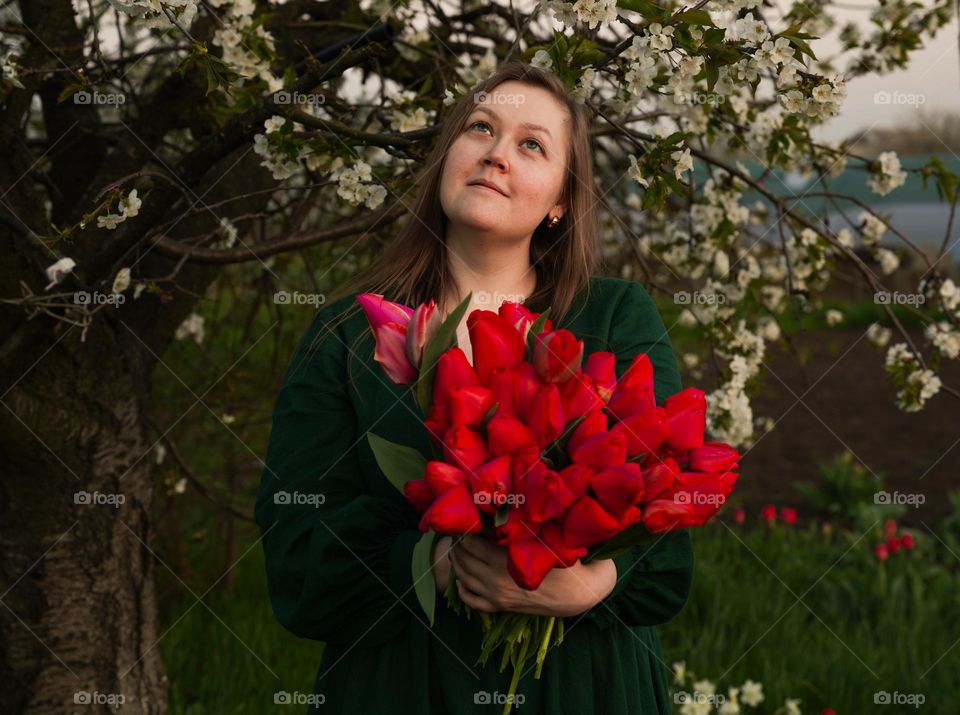 Woman green dress red tulips blossom tree spring smile 