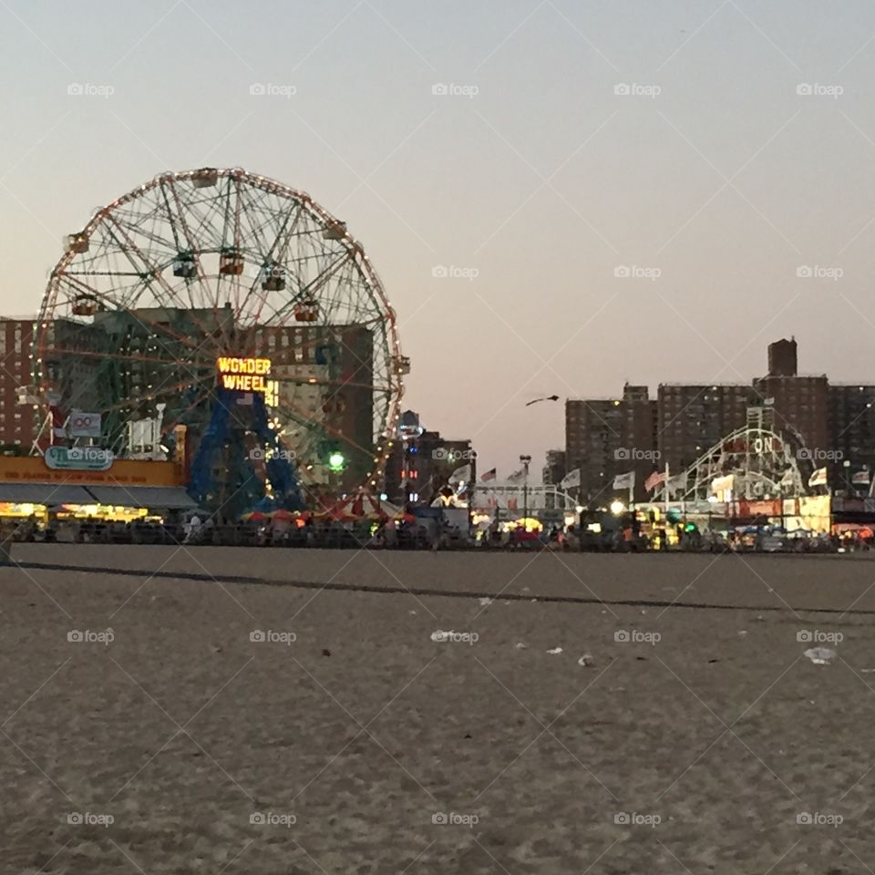 Coney Island, and the Famous Wonder Wheel. A view from the beach in the evening.