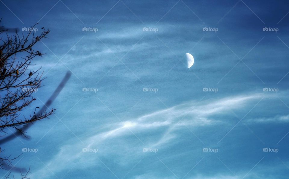 Early evening whispy clouds and the moon.