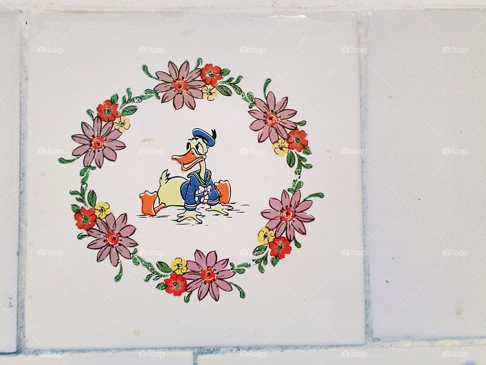 Donald duck and flowers painting on ceramic tile