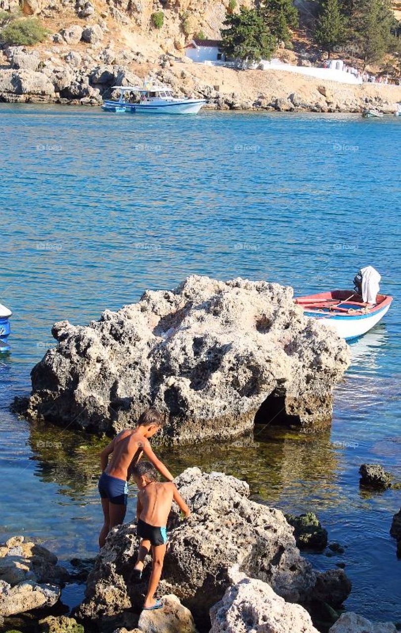 Two boys playing at the rocks