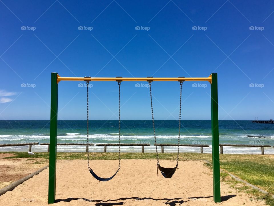 Children's swing set overlooking south Australia ocean horizon 