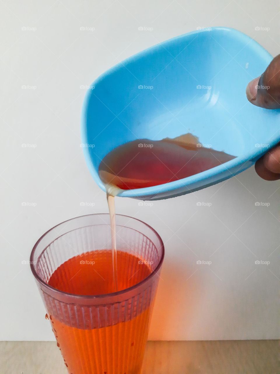 R red liquid poured in a glass