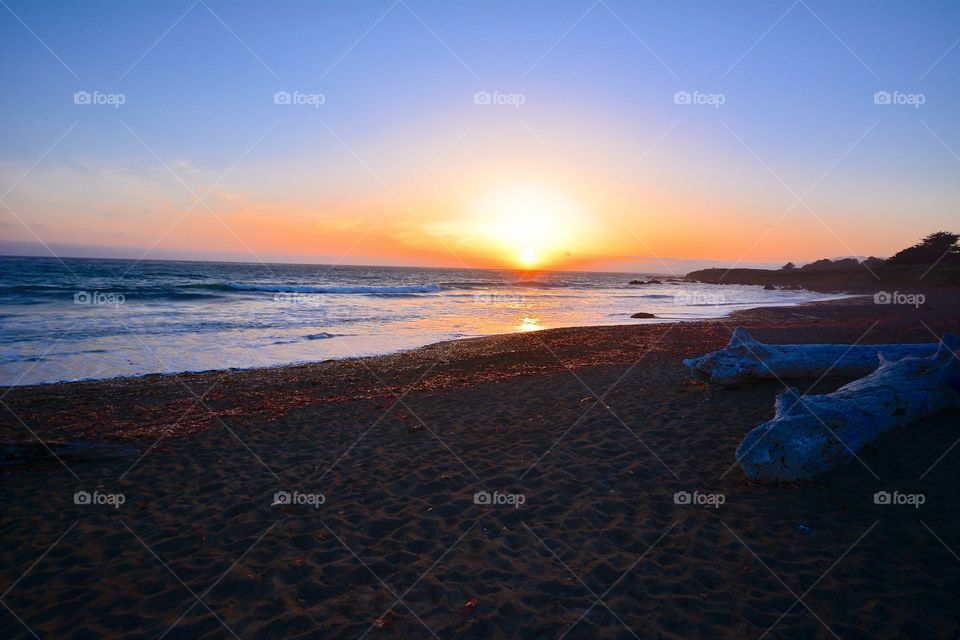 Scenic view of beach at sunset