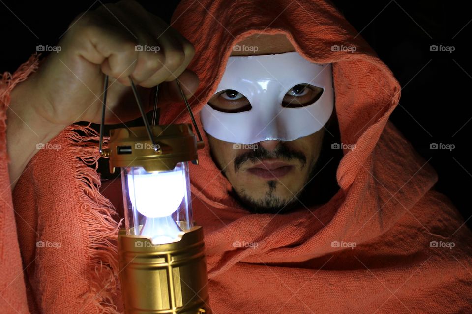 masked man with luminary