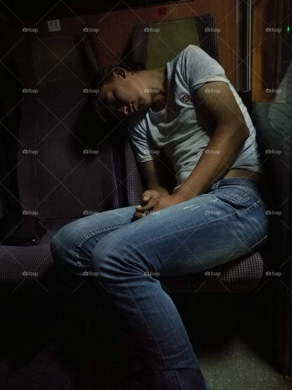 Young Romanian worker taking a nap while riding the train.