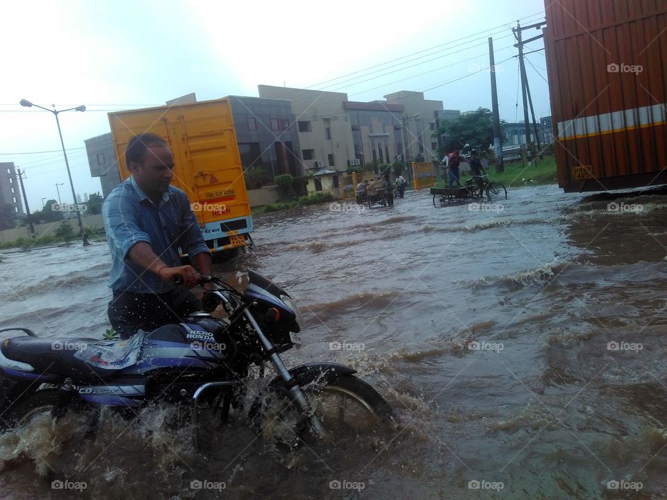 Man with motor bike in flood
