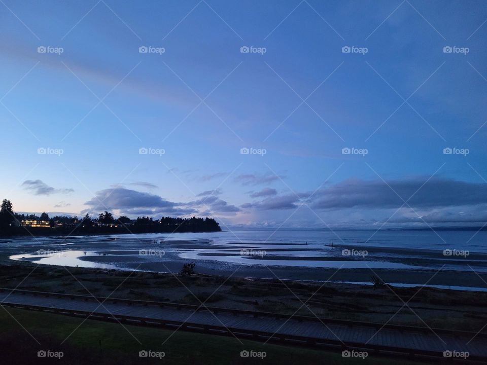 view from the beach of the ocean seascape at Dusk with skies of blue.