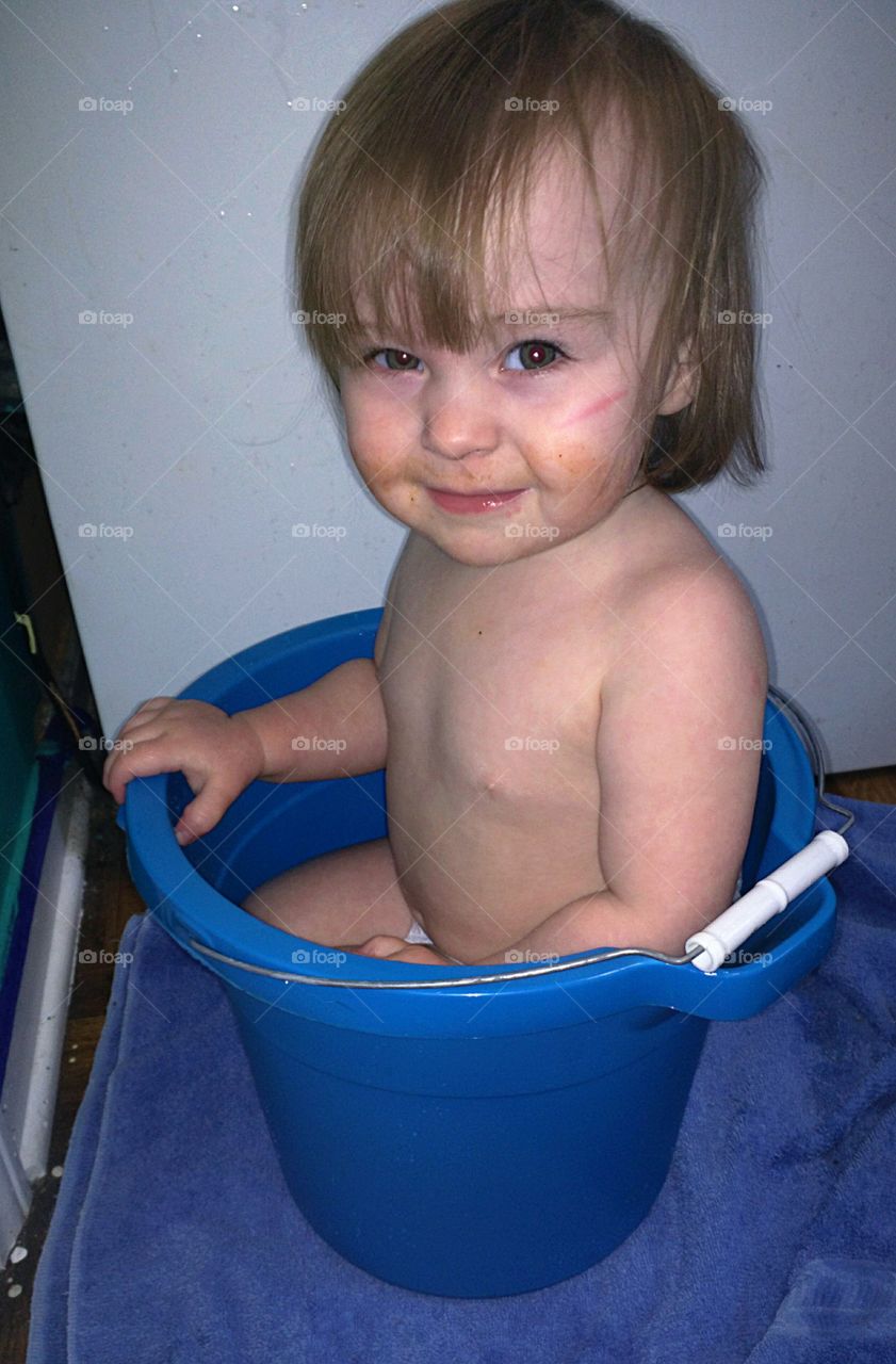 baby in a blue bucket