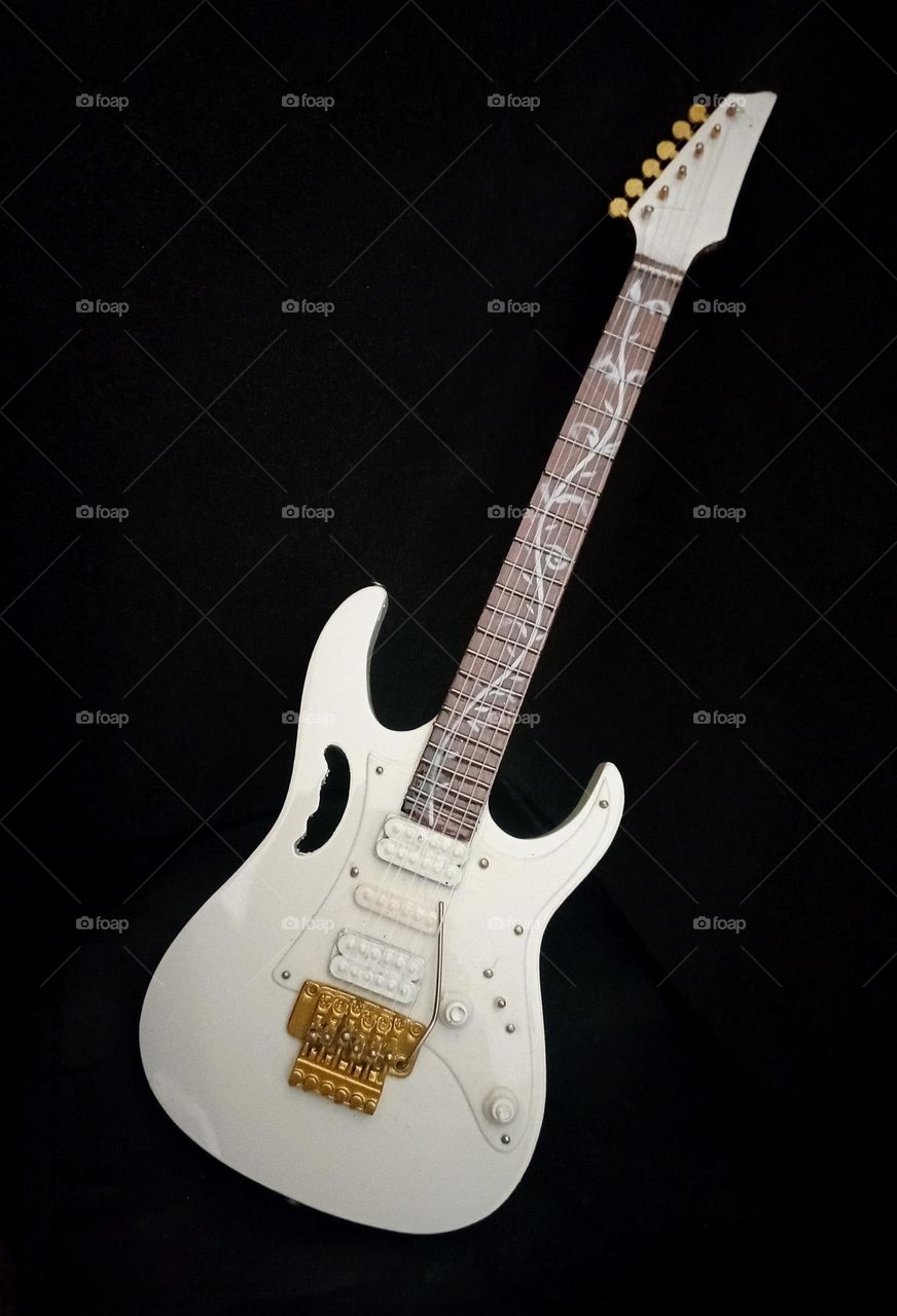 Guitar replicas in a dark background