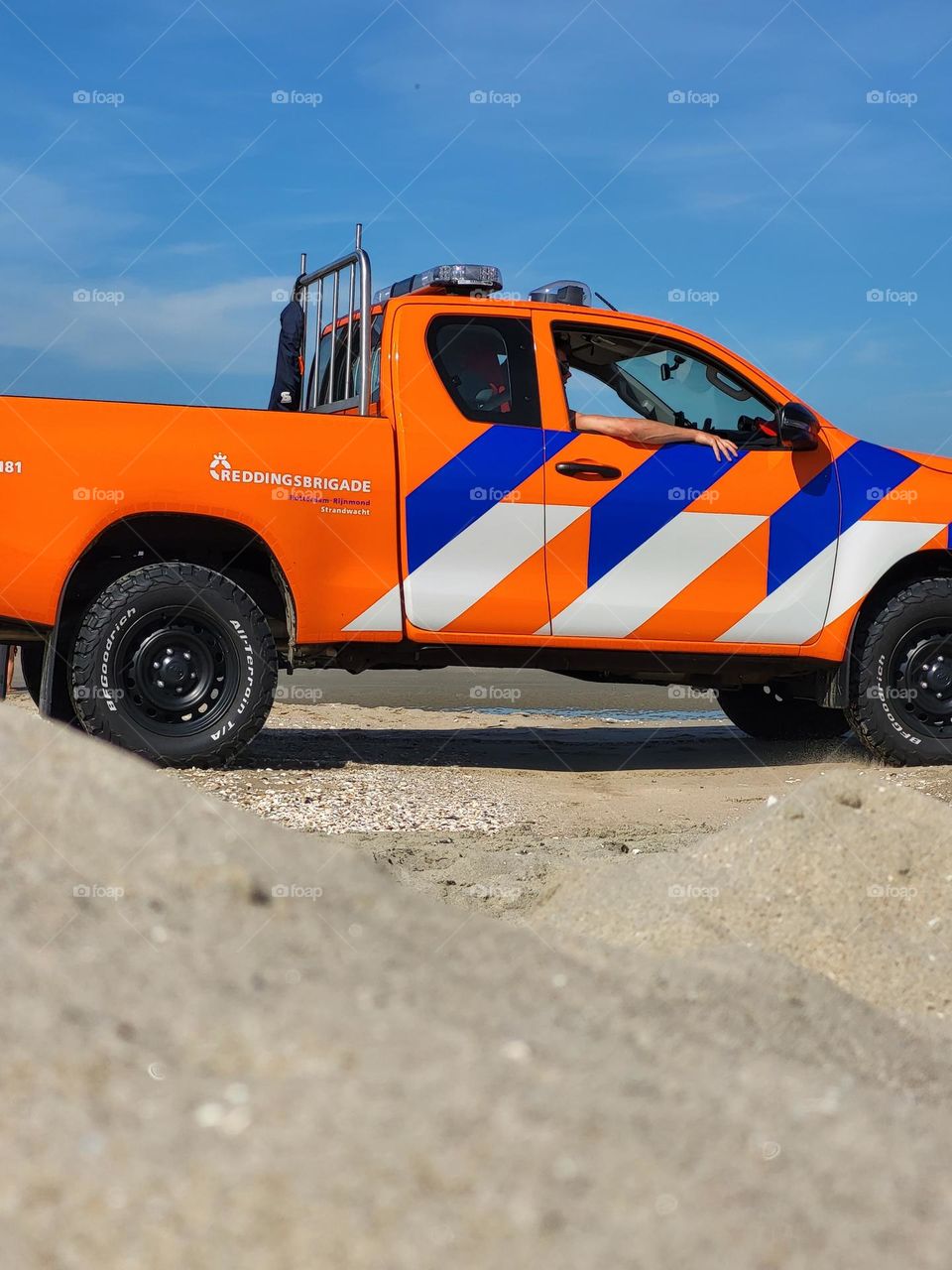 Some people aren't relaxing on the beach. The rescue team drives a good car to do their job well.