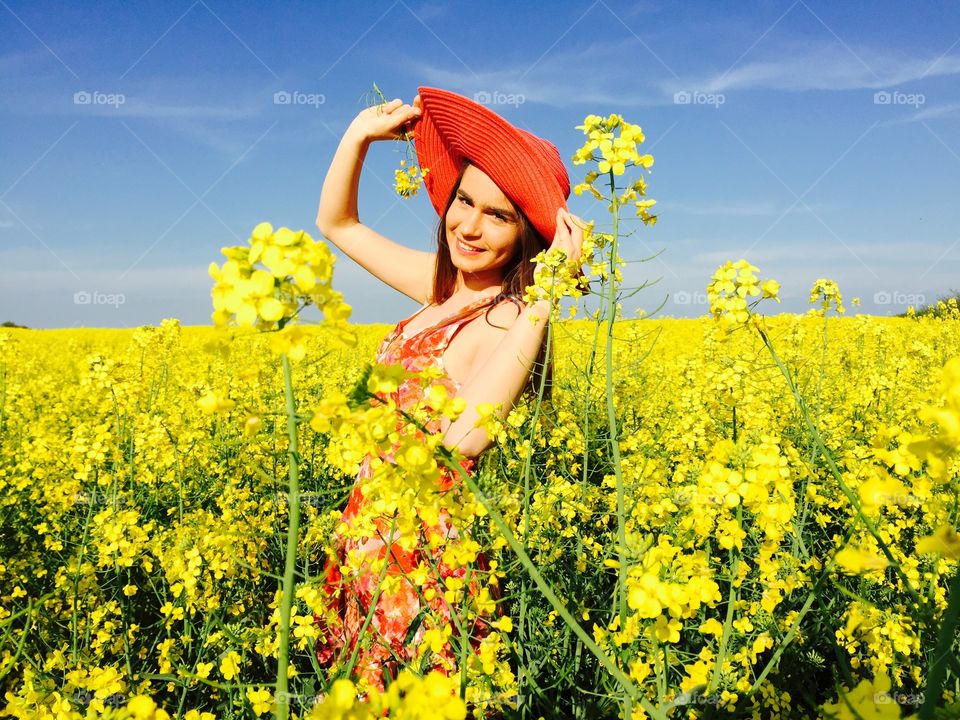 Woman standing in Oilseed Rape field