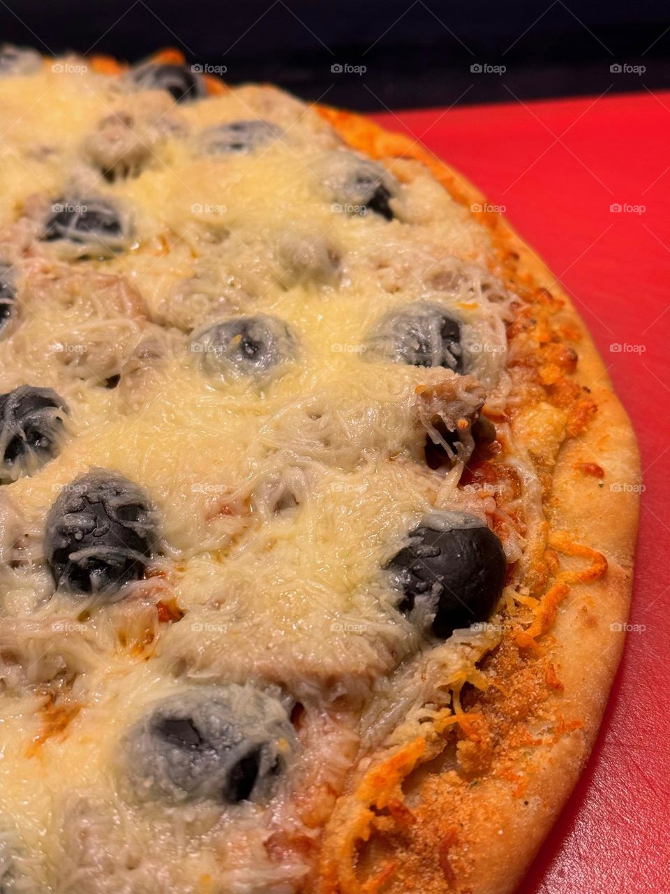 Pizza on a red board.