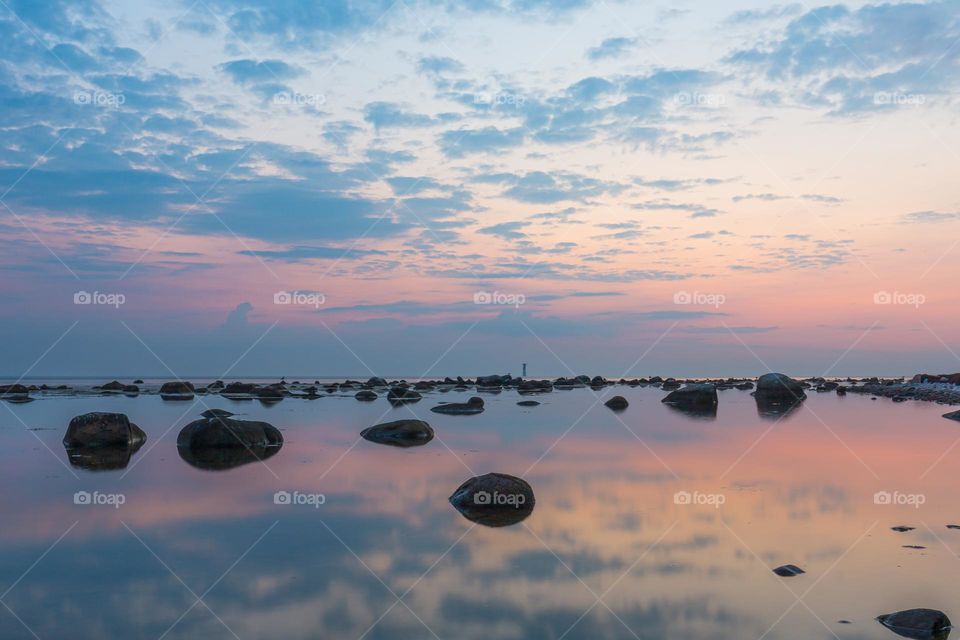 Beautiful peaceful sunset with reflection in the calm ocean on the Swedish west coast 