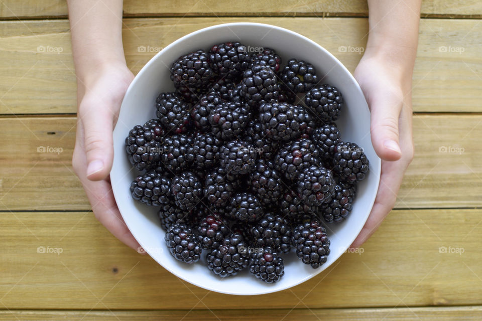 Holding a Bowl of Fresh Blackberries 